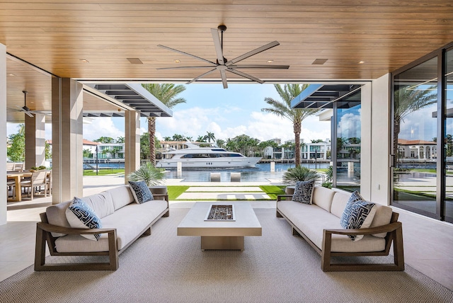 view of patio / terrace featuring an outdoor living space with a fire pit and a water view