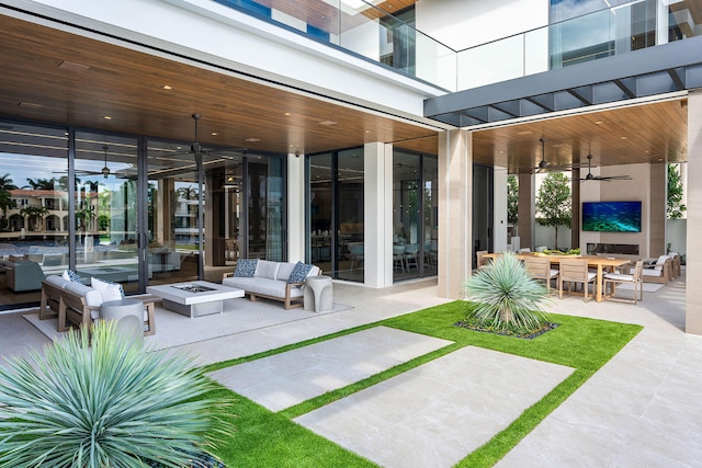 view of patio / terrace with an outdoor living space with a fire pit and ceiling fan