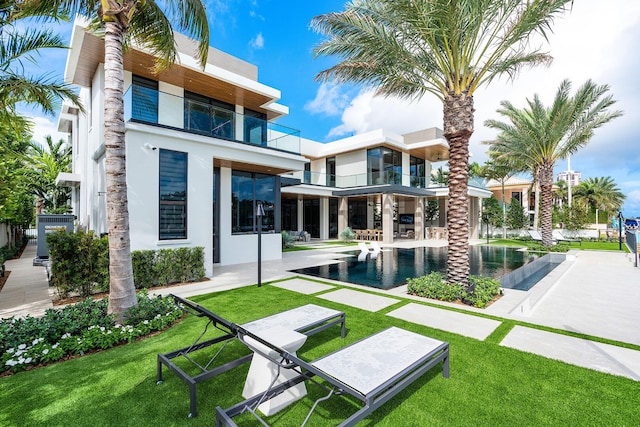 1520 Royal Palm Way, Boca Raton, FL 33432 - back of house featuring stucco siding, an infinity pool, a lawn, and a patio area