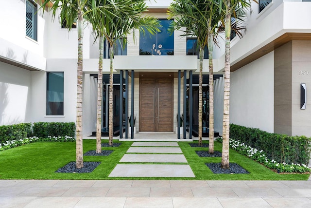 1520 Royal Palm Way, Boca Raton, FL 33432 - entrance to property featuring stucco siding and a lawn