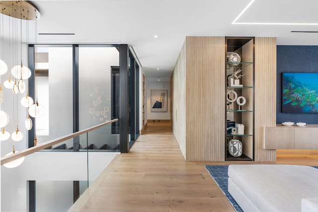 corridor with light hardwood / wood-style flooring