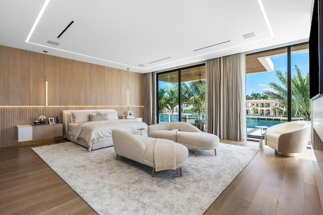 1520 Royal Palm Way, Boca Raton, FL 33432 - bedroom with a wall of windows, access to exterior, wood walls, and wood finished floors