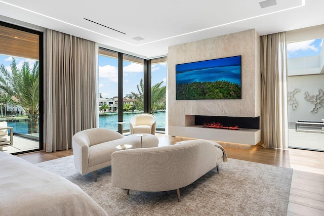 1520 Royal Palm Way, Boca Raton, FL 33432 - bedroom with a wall of windows, access to outside, wood finished floors, multiple windows, and a fireplace