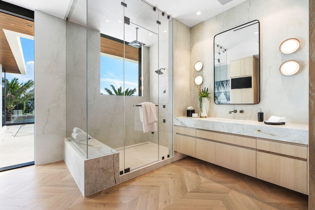 bathroom with vanity, an enclosed shower, and parquet floors