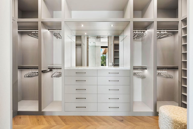 spacious closet with light parquet floors