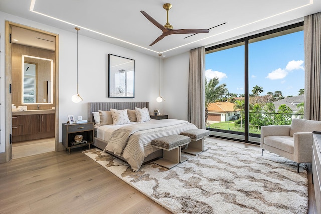 bedroom featuring multiple windows, access to outside, hardwood / wood-style flooring, and ceiling fan