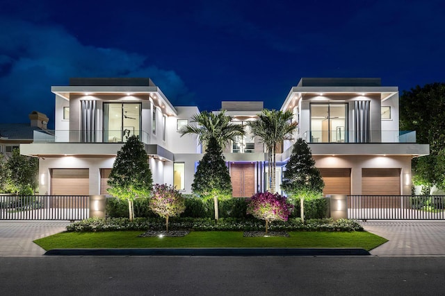 1520 Royal Palm Way, Boca Raton, FL 33432 - modern home featuring a balcony, a garage, stucco siding, and decorative driveway