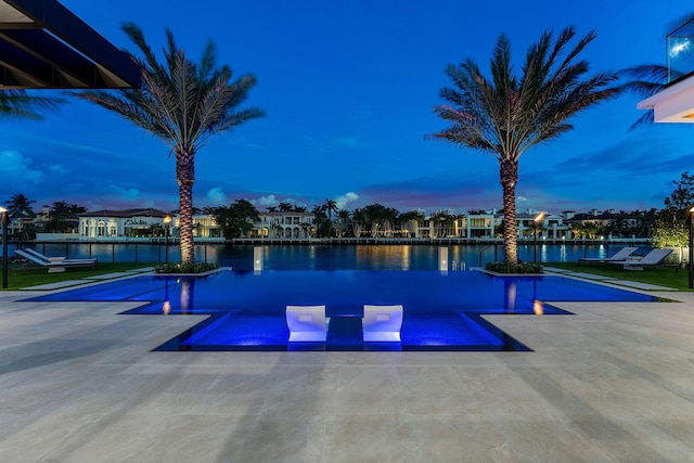 1520 Royal Palm Way, Boca Raton, FL 33432 - view of swimming pool featuring a water view and a patio