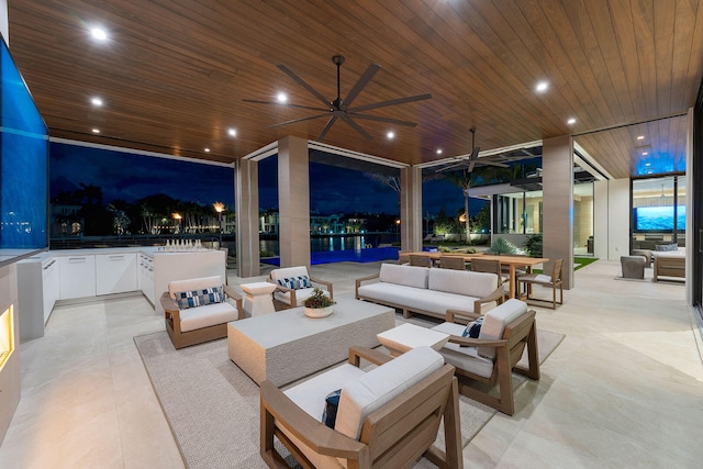 patio at twilight featuring outdoor lounge area and ceiling fan