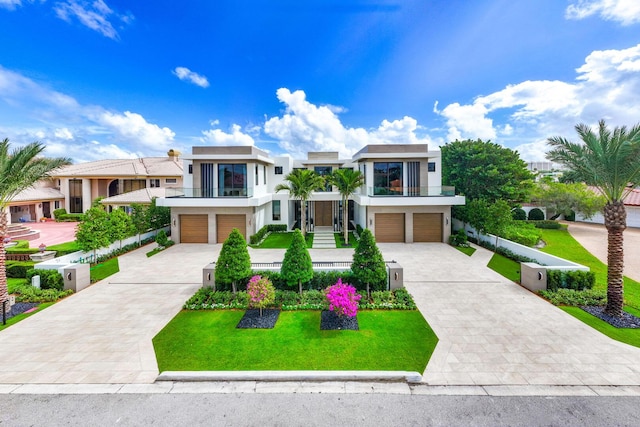 1520 Royal Palm Way, Boca Raton, FL 33432 - contemporary home featuring a balcony, stucco siding, an attached garage, and concrete driveway