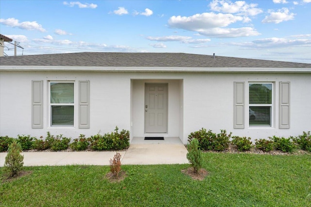 doorway to property with a yard