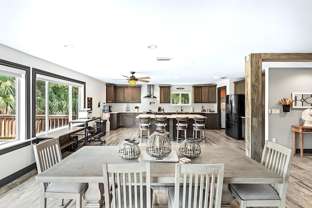 dining room with ceiling fan, light hardwood / wood-style floors, and plenty of natural light