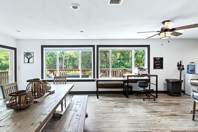 dining room featuring light hardwood / wood-style floors, ceiling fan, and plenty of natural light