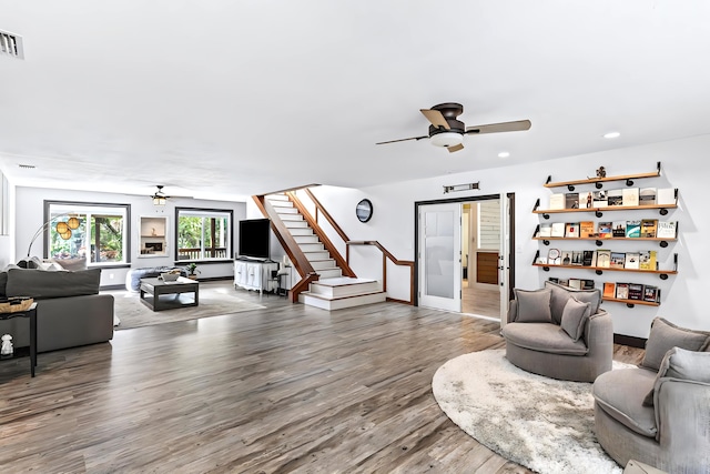 living room with hardwood / wood-style flooring and ceiling fan