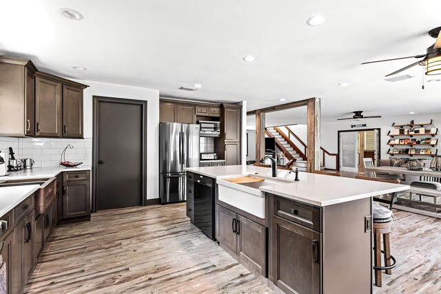 12151 Old Indiantown Rd, Jupiter, FL 33478 - kitchen featuring stainless steel appliances, a sink, a ceiling fan, dark brown cabinetry, and light countertops