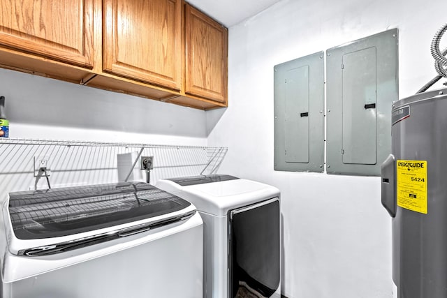 laundry area with electric panel, cabinets, washing machine and dryer, and electric water heater