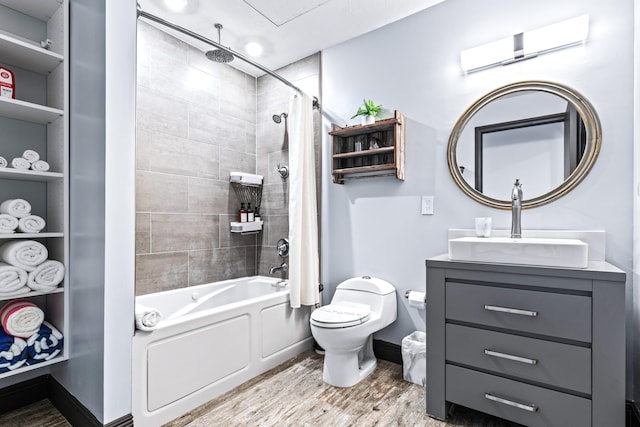 full bathroom featuring hardwood / wood-style floors, vanity, shower / bath combination with curtain, and toilet