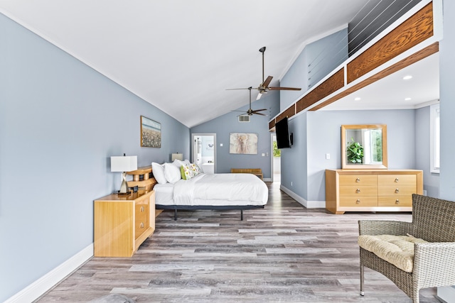 bedroom featuring multiple windows, hardwood / wood-style flooring, ceiling fan, and vaulted ceiling