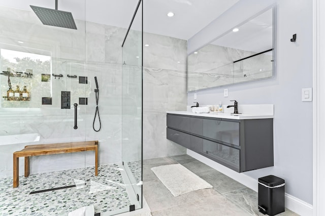 bathroom featuring a shower with shower door and vanity