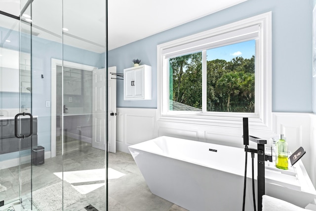 12151 Old Indiantown Rd, Jupiter, FL 33478 - full bath featuring a decorative wall, a shower stall, a wainscoted wall, a soaking tub, and marble finish floors
