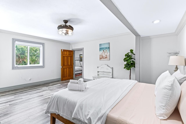 bedroom featuring light hardwood / wood-style floors and crown molding