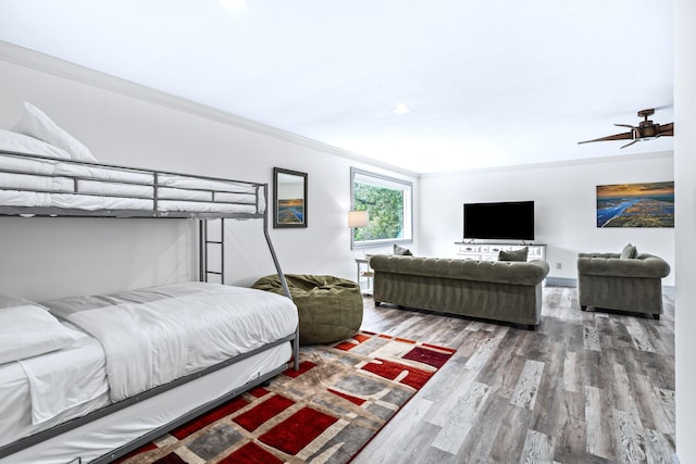 bedroom with ceiling fan, wood-type flooring, and ornamental molding