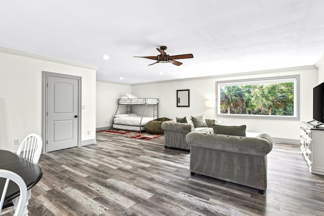 bedroom featuring ornamental molding, dark wood-type flooring, and ceiling fan