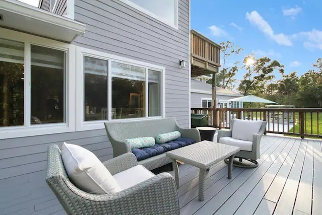 wooden terrace featuring outdoor lounge area