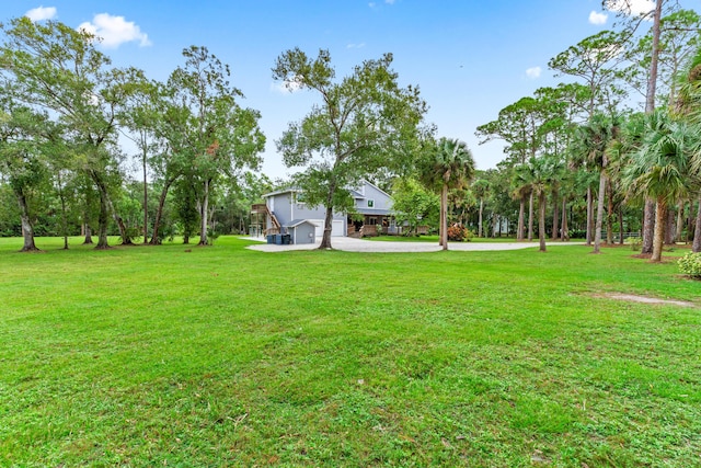 12151 Old Indiantown Rd, Jupiter, FL 33478 - view of green lawn featuring driveway