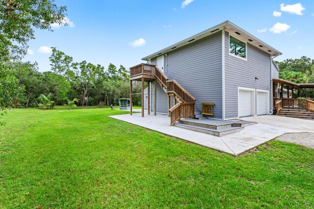 12151 Old Indiantown Rd, Jupiter, FL 33478 - back of house with a deck, stairway, concrete driveway, and an attached garage
