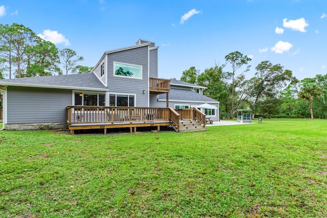 12151 Old Indiantown Rd, Jupiter, FL 33478 - rear view of property featuring a deck, a lawn, roof with shingles, a chimney, and a sunroom