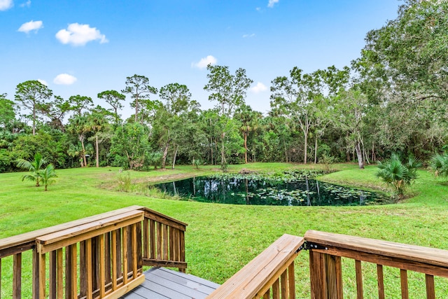 view of yard featuring a deck with water view