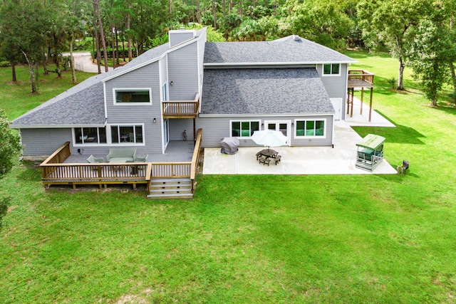 back of house with an outdoor hangout area, a lawn, a wooden deck, and a patio area