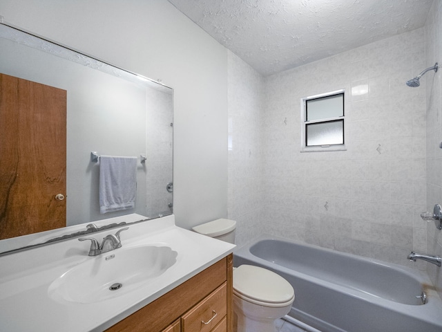 full bathroom with toilet, tiled shower / bath combo, vanity, and a textured ceiling