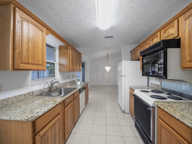 kitchen with sink, a textured ceiling, light tile patterned floors, decorative light fixtures, and white appliances