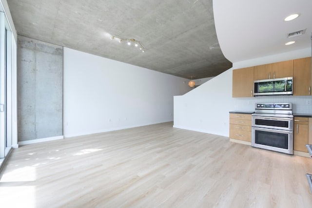 kitchen featuring stainless steel appliances and light hardwood / wood-style flooring