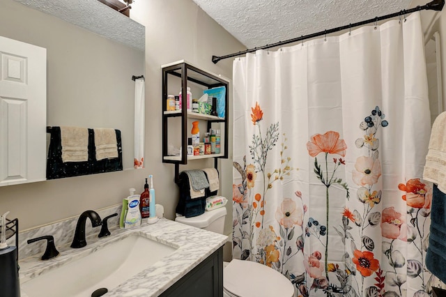 bathroom with vanity, a textured ceiling, toilet, and a shower with shower curtain