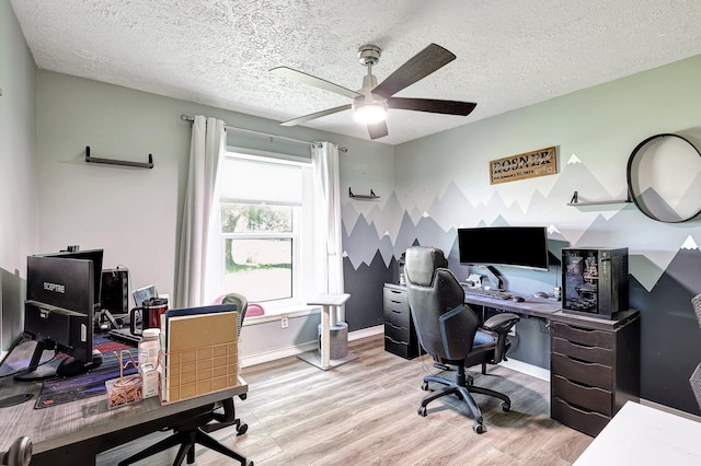 office space with a textured ceiling, ceiling fan, and light hardwood / wood-style flooring