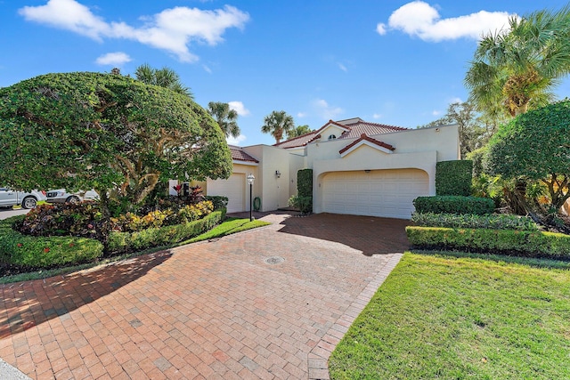 mediterranean / spanish-style home with a garage