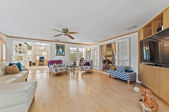 living room with french doors, light wood-type flooring, ceiling fan, and ornamental molding