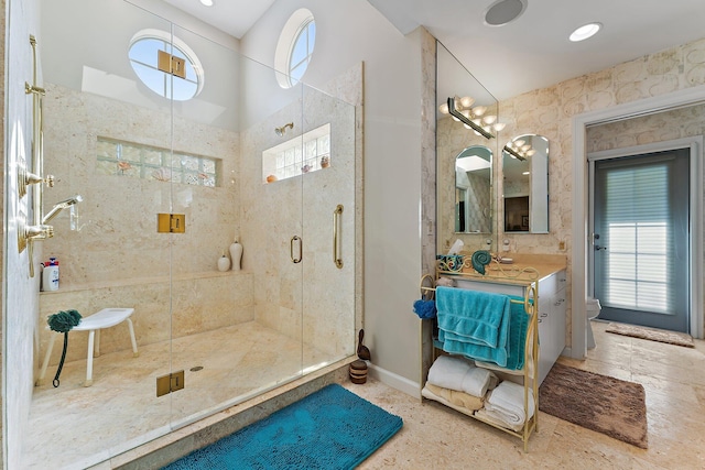 bathroom featuring vanity, toilet, and a shower with shower door