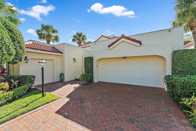 mediterranean / spanish-style home with a garage