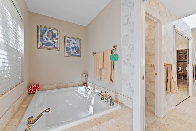 bathroom featuring tiled tub