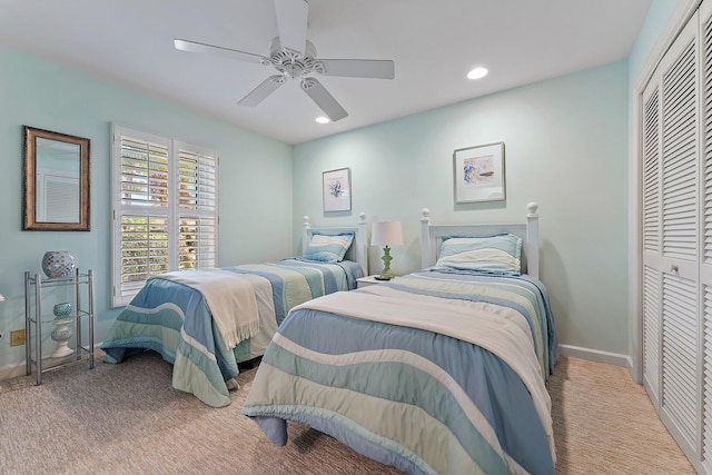 bedroom with light carpet, a closet, and ceiling fan