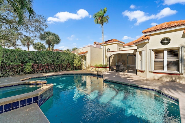 view of swimming pool with a sunroom, an in ground hot tub, and a patio