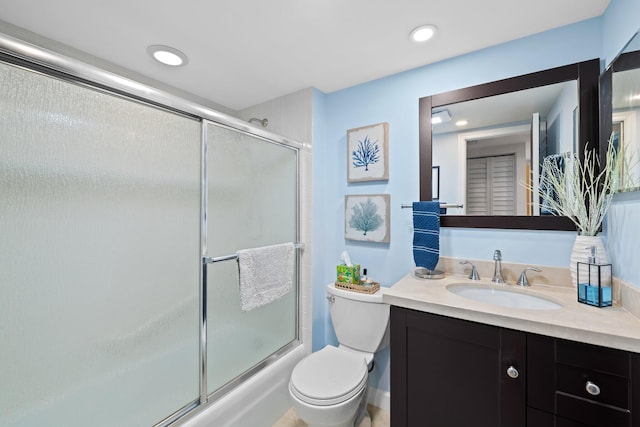 full bathroom with toilet, vanity, and enclosed tub / shower combo