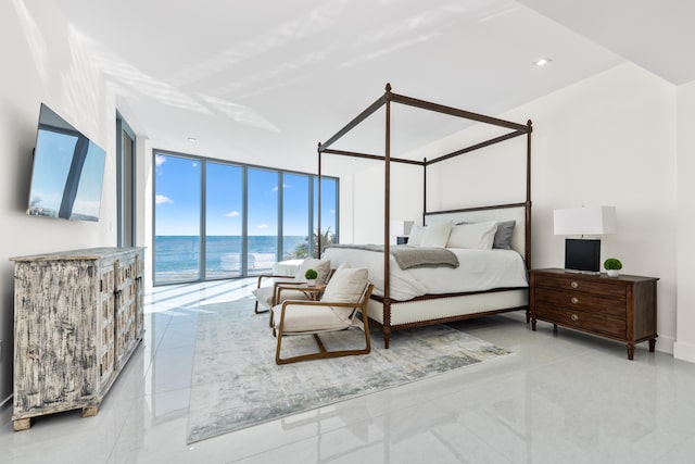 tiled bedroom featuring access to outside and a wall of windows