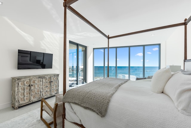 bedroom with access to exterior and a water view