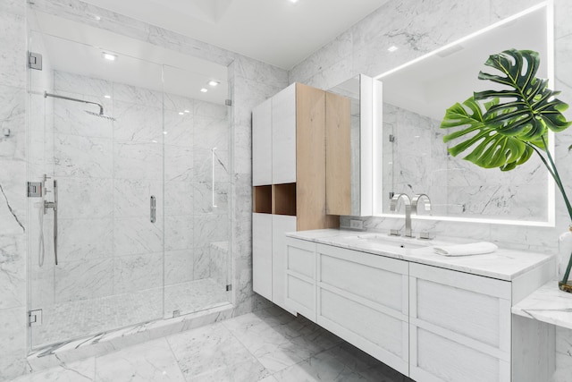 bathroom featuring vanity, an enclosed shower, and tile walls