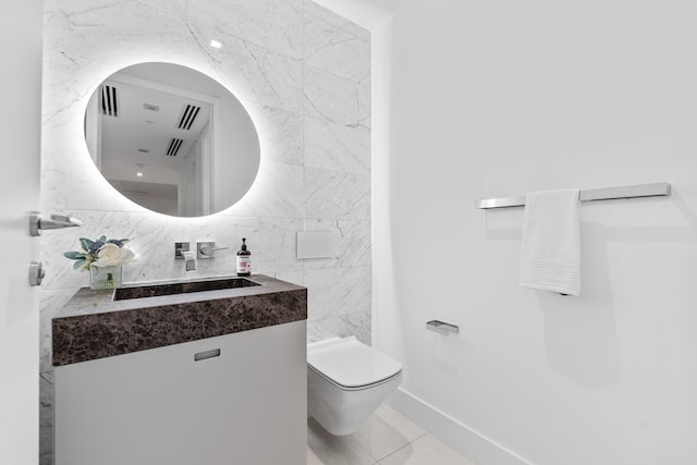 bathroom featuring toilet, vanity, decorative backsplash, and tile patterned flooring